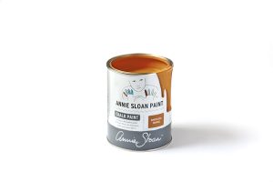 An open tin of Annie Sloan Chalk Paint in a bright burnt orange colour