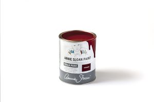 An open tin of Annie Sloan Chalk Paint in a vibrant burgundy red colour