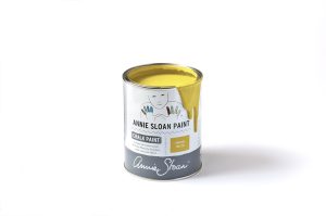 An open tin of Annie Sloan Chalk Paint in a bright yellow colour