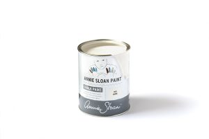 A tin of Annie Sloan Chalk Paint in a soft white tone