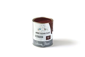 An open tin of Annie Sloan Chalk Paint in a deep red colour