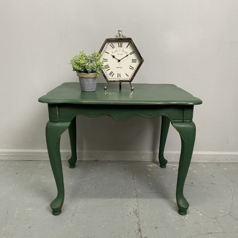 A French Provincial side table with cabriole legs, painted in a forest green colour.