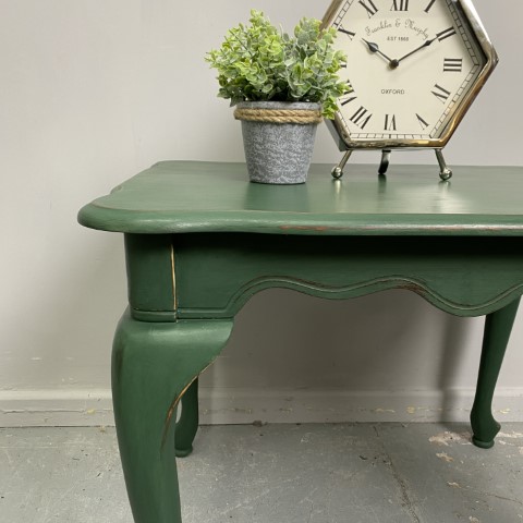 A French Provincial side table with cabriole legs, painted in a forest green colour.