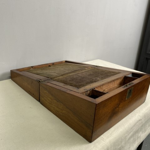 An antique writing slope in a walnut timber colour