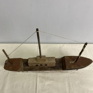 A decorative rustic sailing boat with three masts without sails made from reclaimed wood.