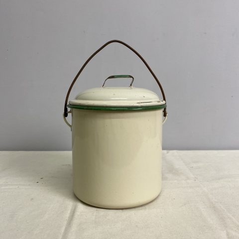 A cream coloured vintage enamel cannister with lid and carry handle. It has a green colour on the rim and lid handle.