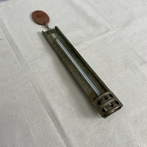 A vintage kitchen thermometer