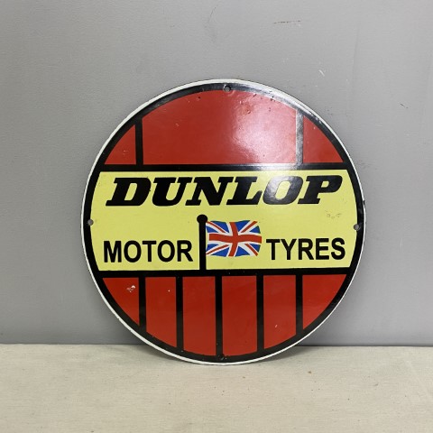 Round enamel sign featuring vintage print of Dunlop Motor Tyres advertisement