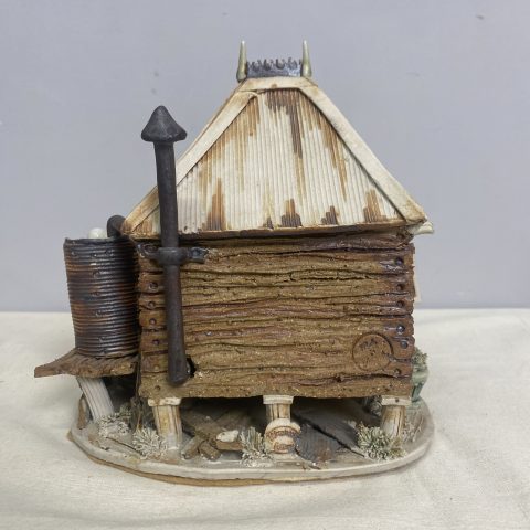 A handmade pottery model of an Australian cabin