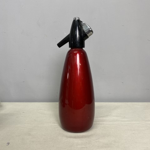 A vintage red anodised soda syphon