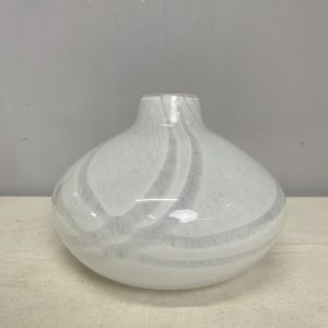 A short, wide white glass vase with minimal swirl pattern