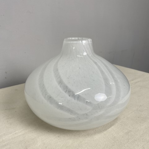 A short, wide white glass vase with minimal swirl pattern