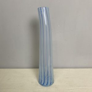 A tall, thin art glass vase with light blue stripes