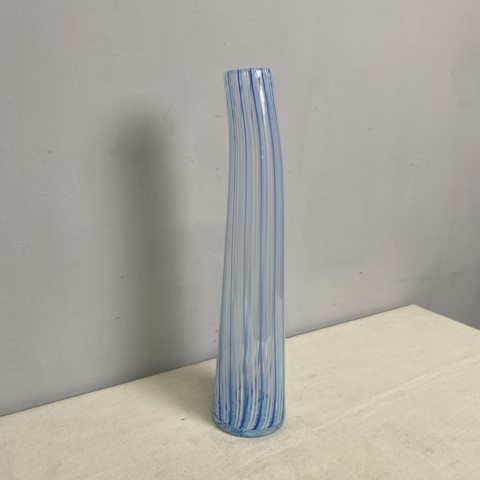 A tall, thin art glass vase with light blue stripes