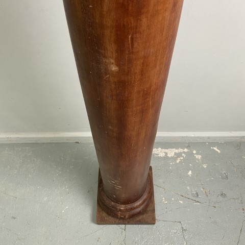 A tall, solid timber pedestal