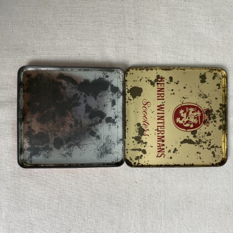 A vintage flat, square tobacco tin for Henri Winterman's 'Scooters'