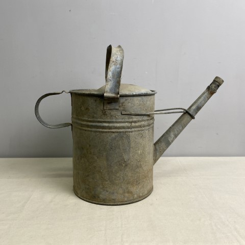A rustic vintage watering can