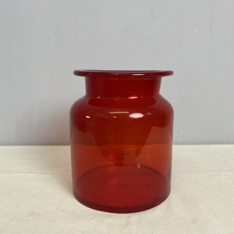 A large red glass jar