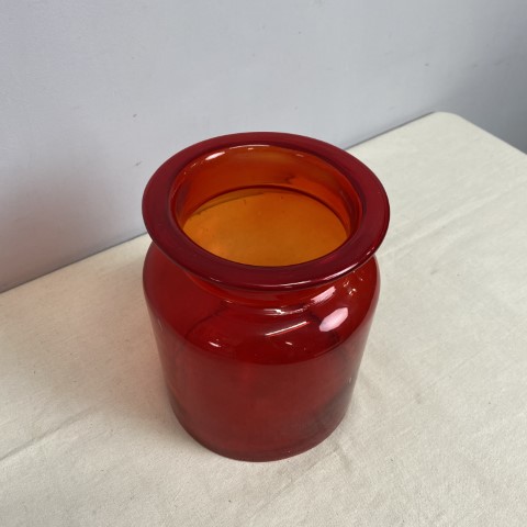 A large red glass jar