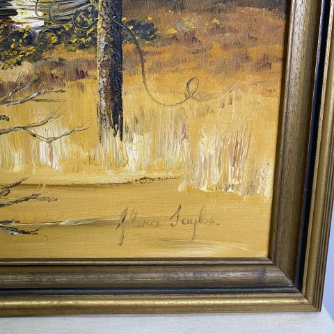 A framed oil painting of an Australian Outback scene. Colouring is yellows and browns.