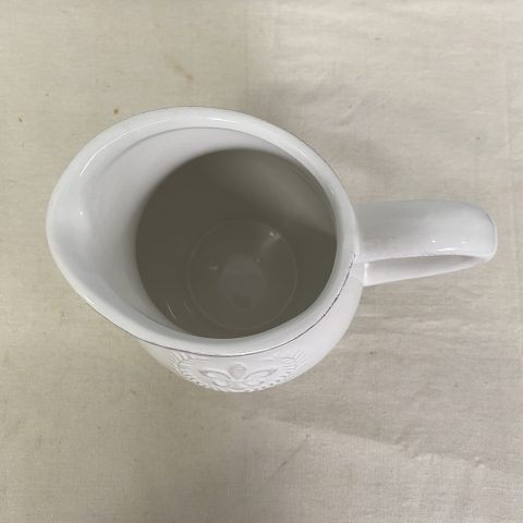 White ceramic jug with embossed fleur de lis decal