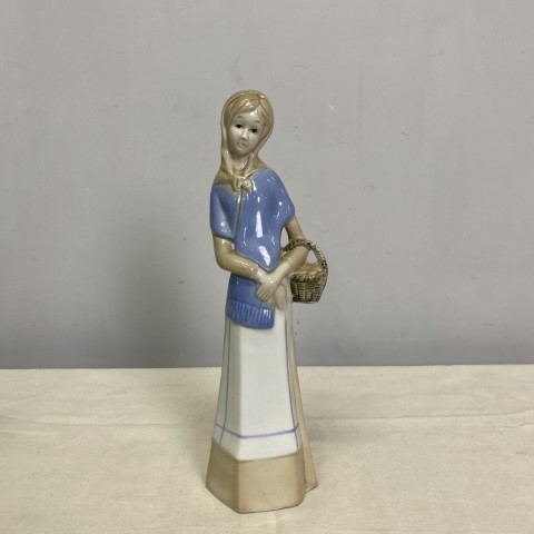 Lladro Style Figurine of a woman holding a basket