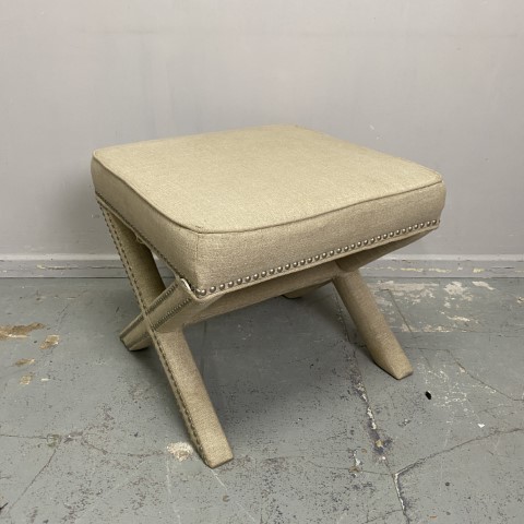 Beige Upholstered Footstool with Cross Legs and Studded Detail